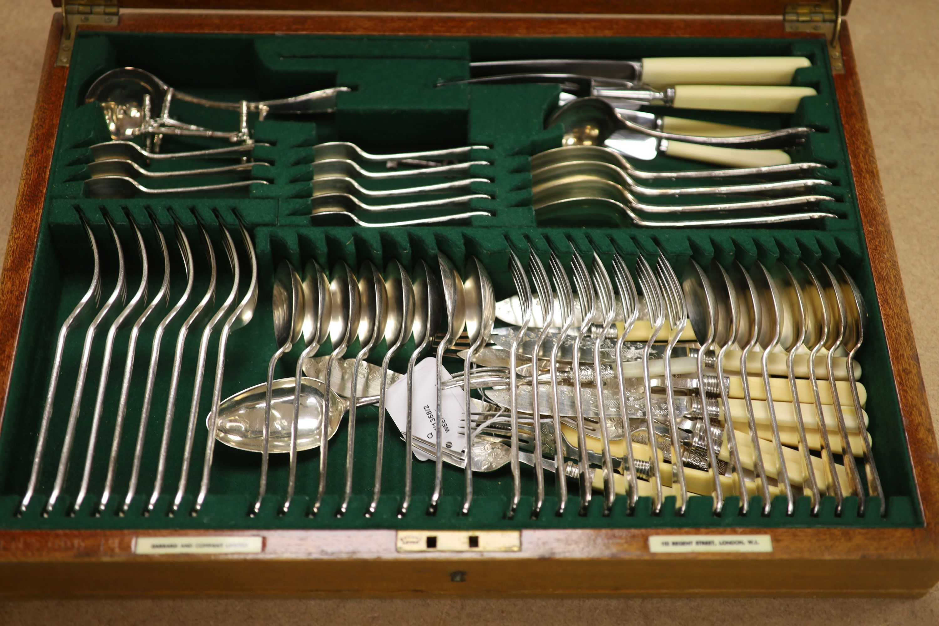 A Garrard & Co service of plated flatware in mahogany canteen, a pair of plated bottle coasters and a plated tray